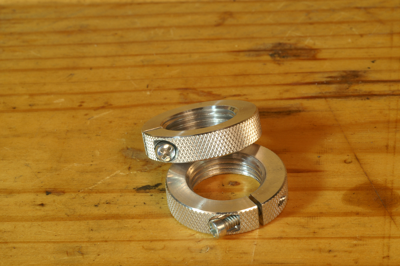 I prefer clamping lock rings, like these from Forster. Those with a set screw can cock when the screw tightens in against the angled threads.