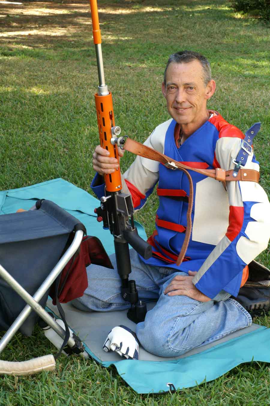 Glen Zediker with competition rifle, sling and competition gear