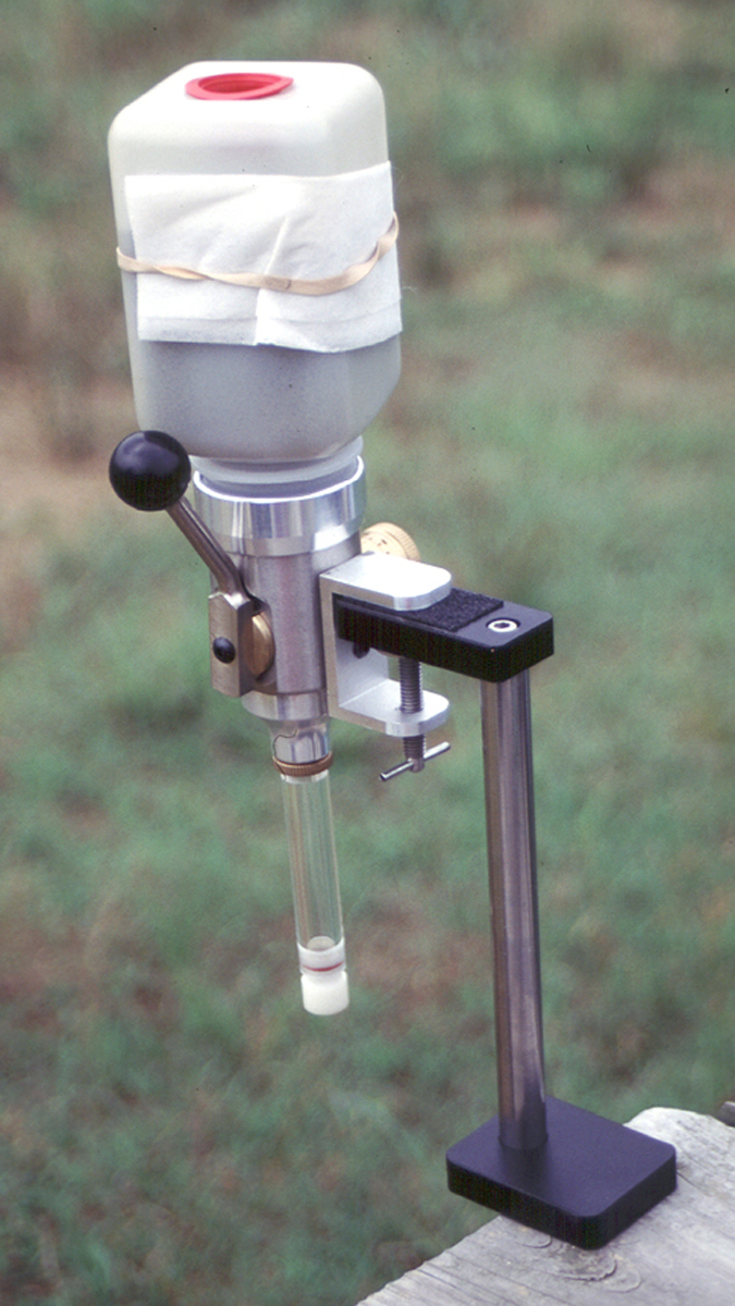 The author recommends longer drop tubes, whether it’s for a meter or a funnel. The longer tube has the same effect as tapping the case to settle the propellant. This helps when loading stick propellant into small cases, like .223 Rem. A dryer sheet rubber-banded around the propellant container eliminates static influence, which indeed can be an influence, especially in the Western regions. And do not leave propellant in a meter! Return it to a sealed container when you’re done for the day. This setup is a Harrell’s Classic with a Sinclair stand.