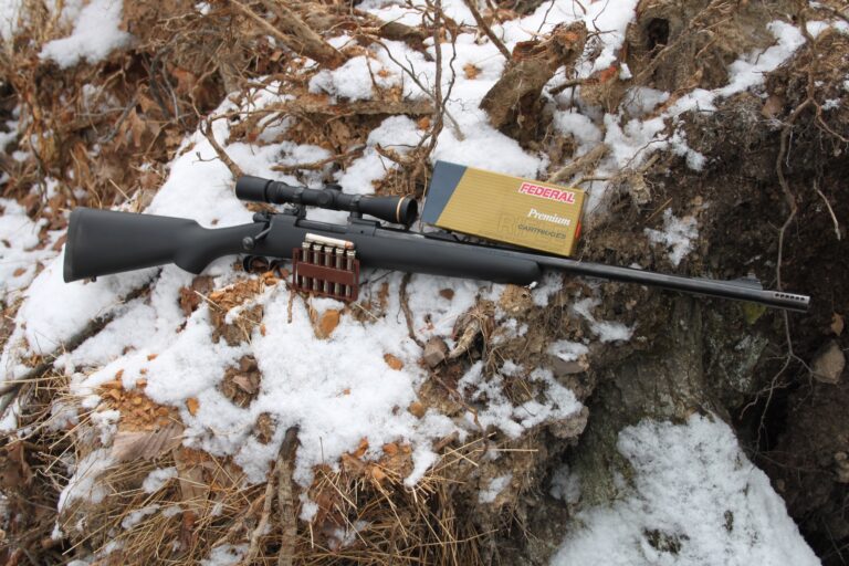 rifle lying in the dirt and snow