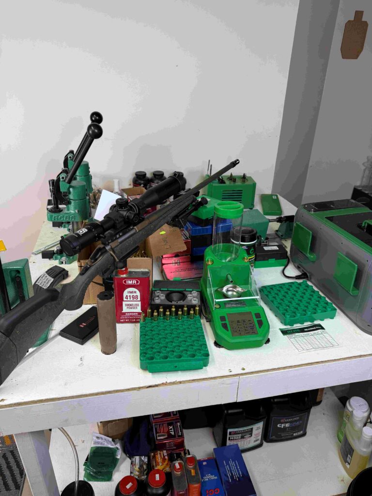 A large 4x8 reloading bench that accommodates three RCBS reloading presses, RCBS powder dispenser, RCBS ultrasonic, RCBS cleaner, and RCBS trimmer.