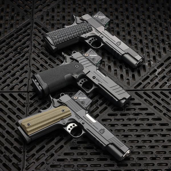Three pistols on a grid pattern pad