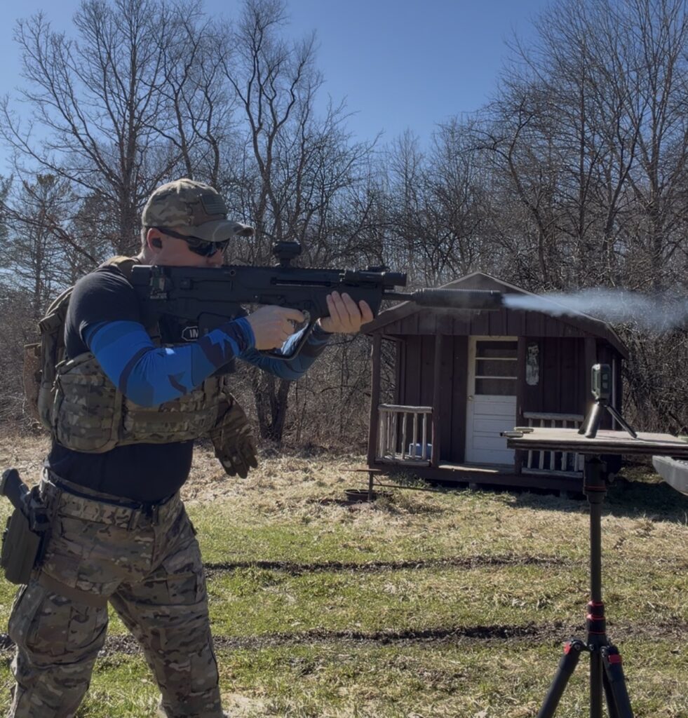 Man standing with rifle firing