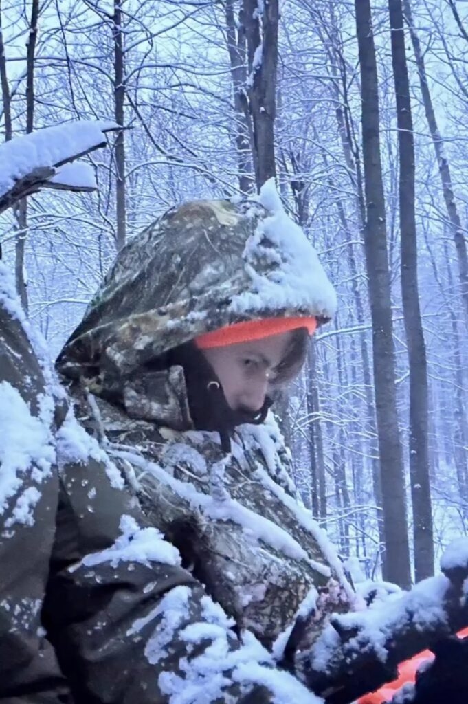 Child in camo. during snowstorm