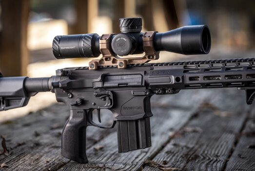 Meprolight optic on rifle sitting on bench