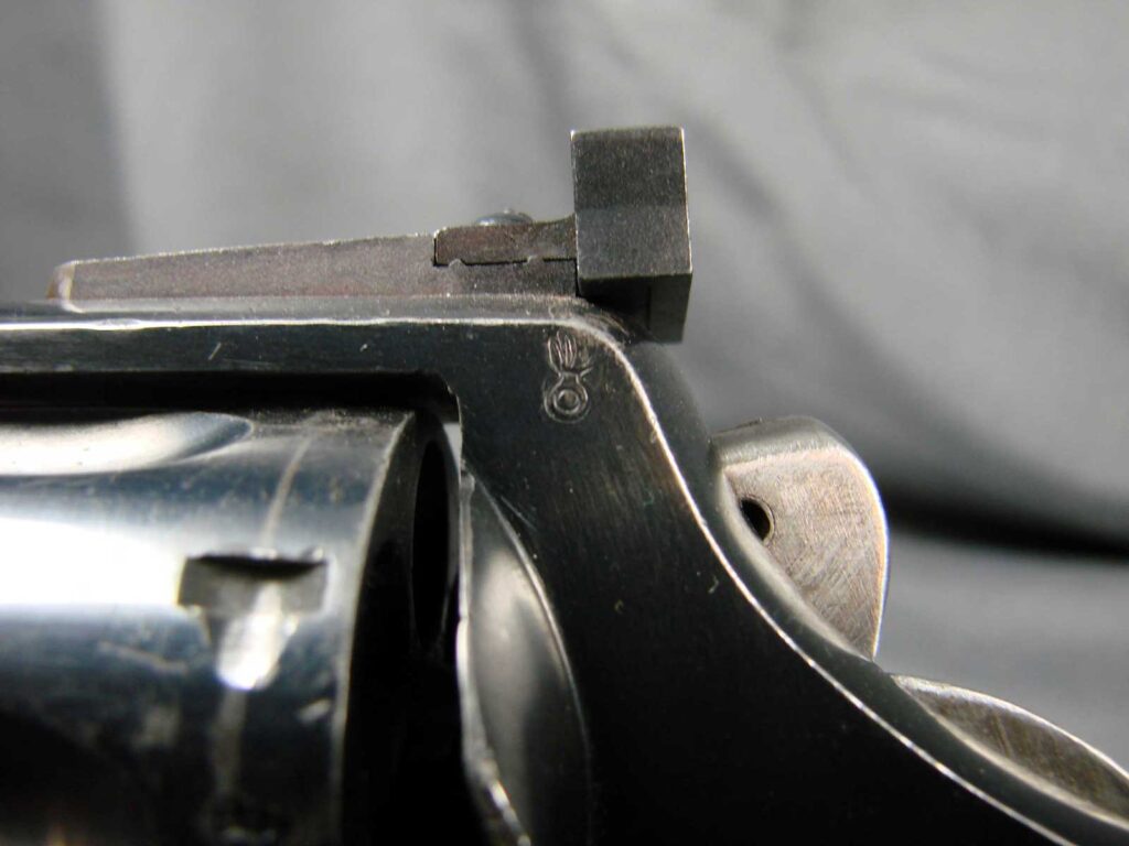 closeup of revolver with military stamp displayed