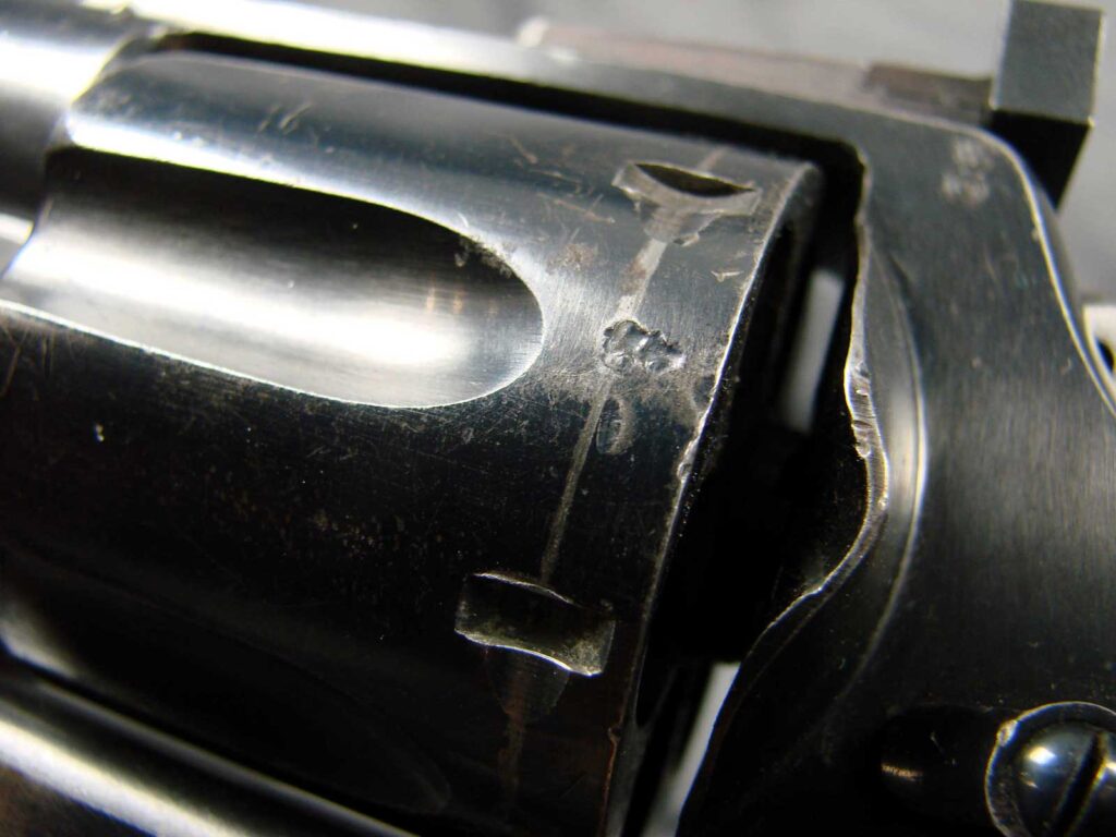 Closeup of revolver cylinder with stamped lettering
