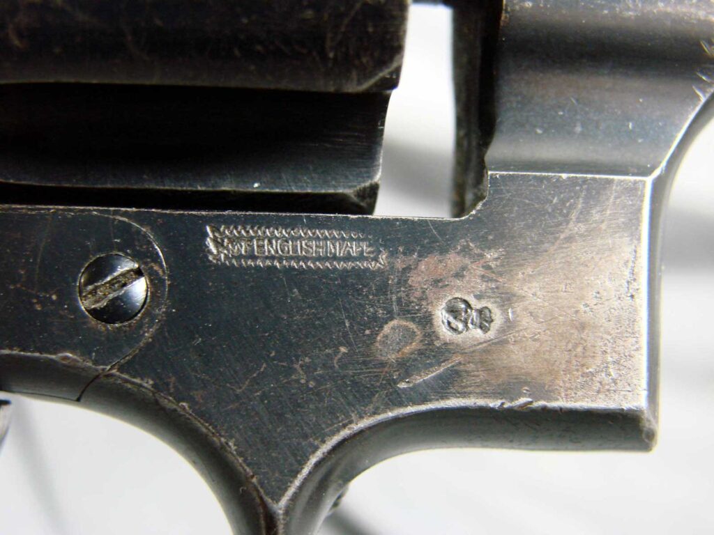 closeup of revolver with stamped lettering