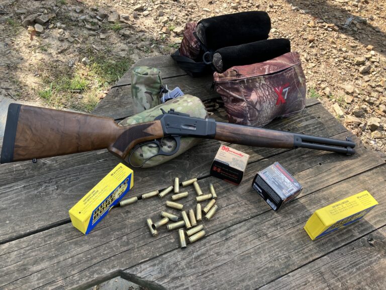 rifle on bench with supplies and brass