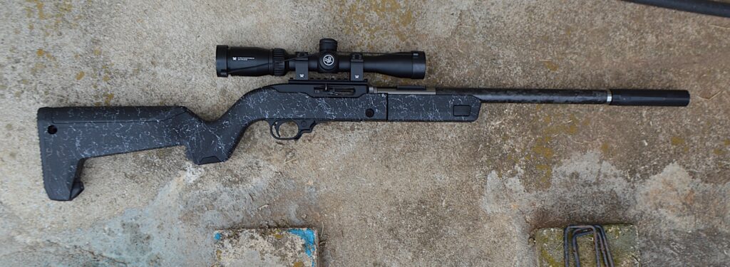 rifle on ground with afixed suppresor
