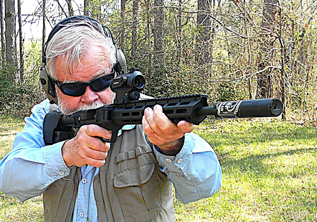 Man shooting rifle in woods