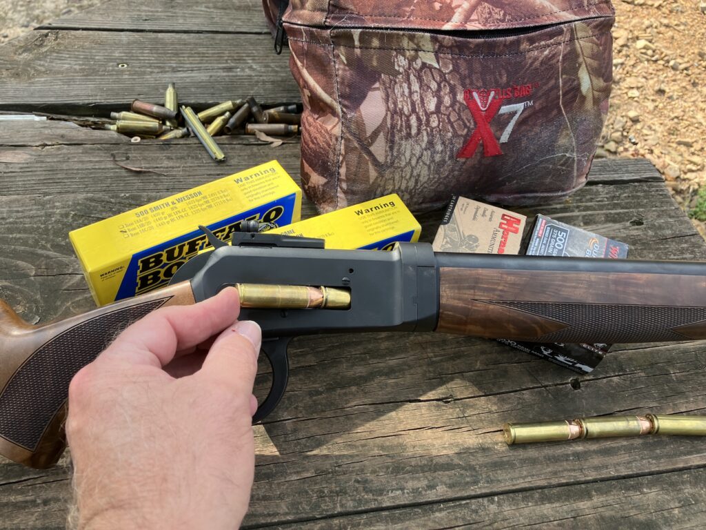 ammunition being inserted into rifle loading port