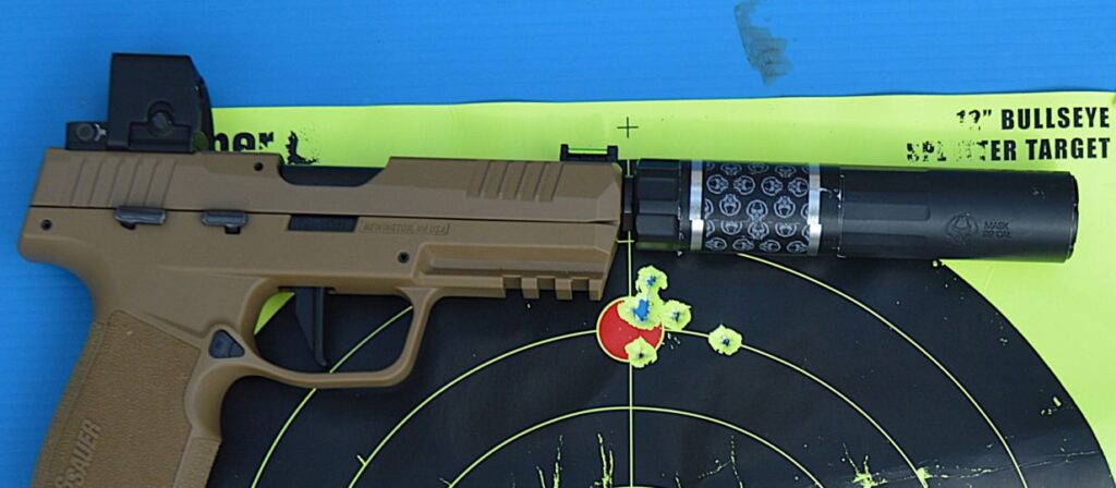 suppressor and pistol with optic laying on reflective target
