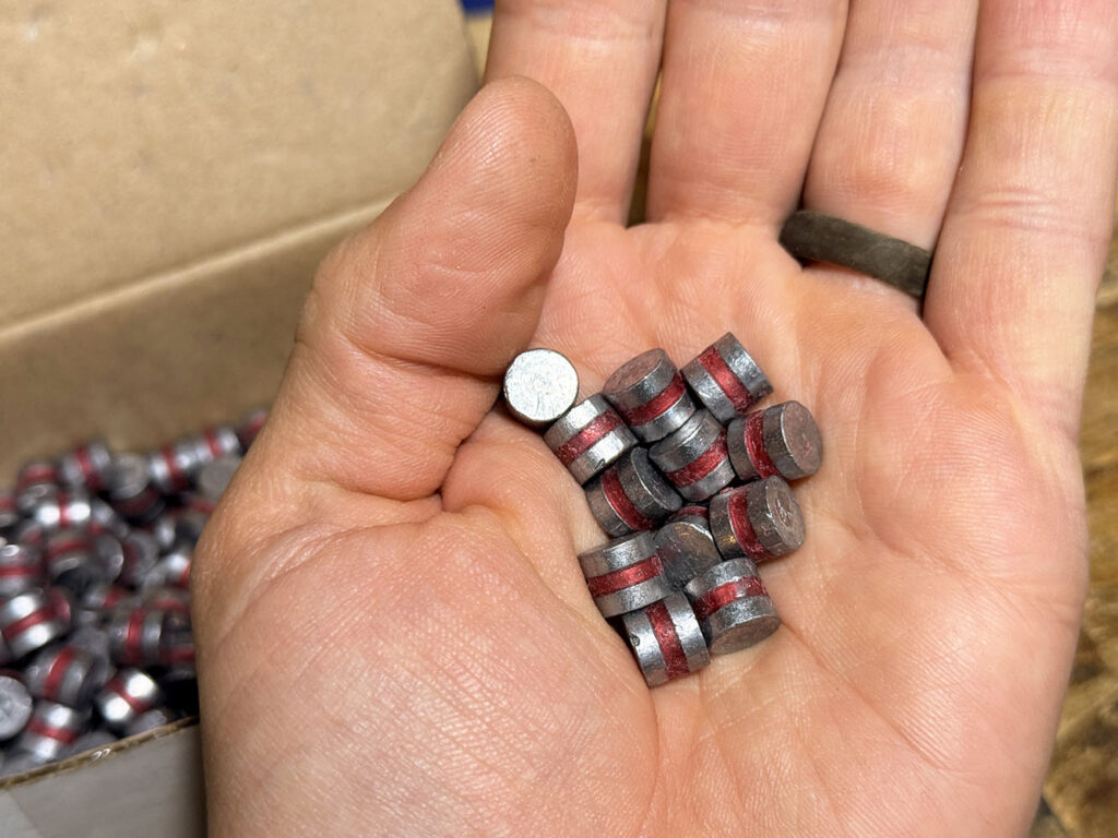 Hand holding cast projectiles