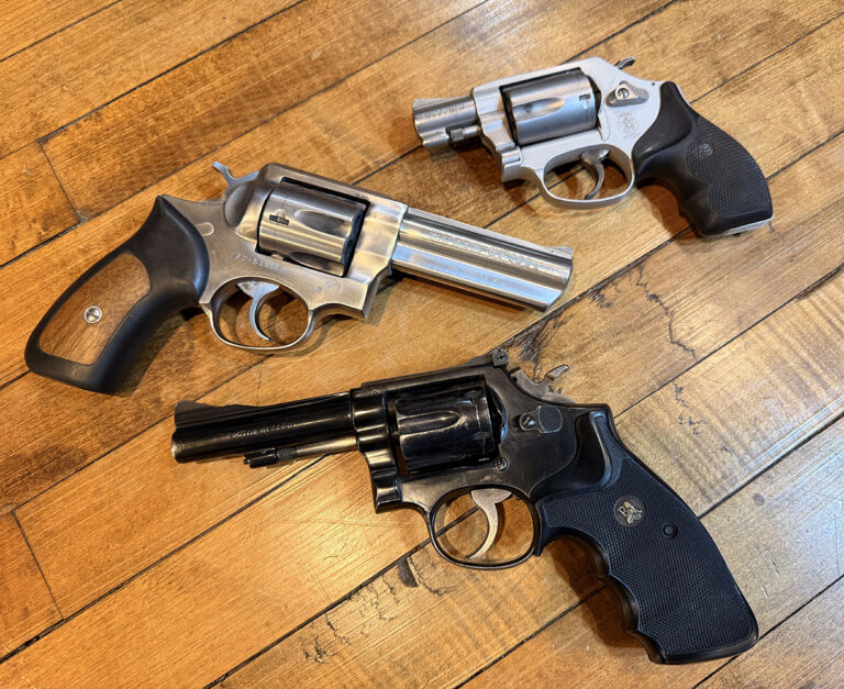 Revolvers sitting on a wooden floor