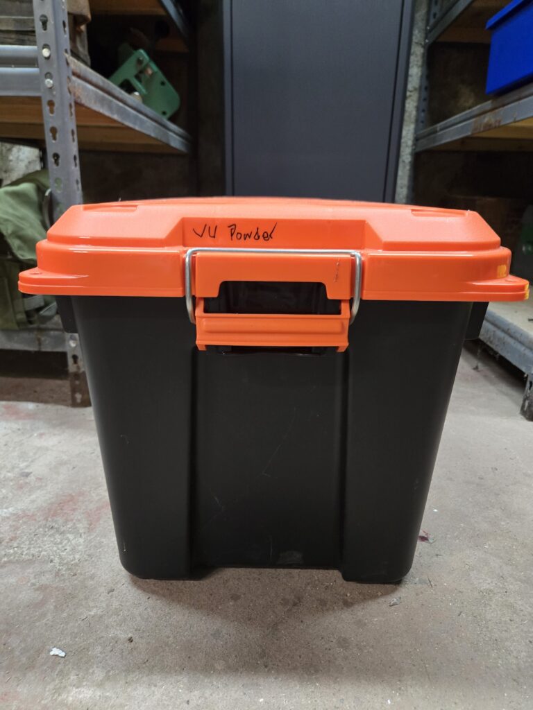 an orange top container with the words 'open powder' written on the side