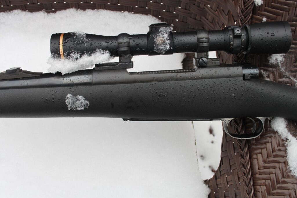 optic on rifle in snow