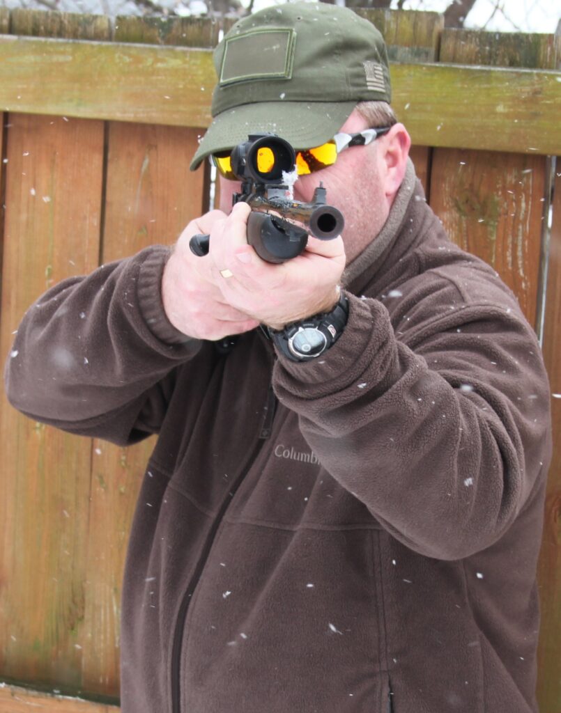 Man holding a rifle while standing